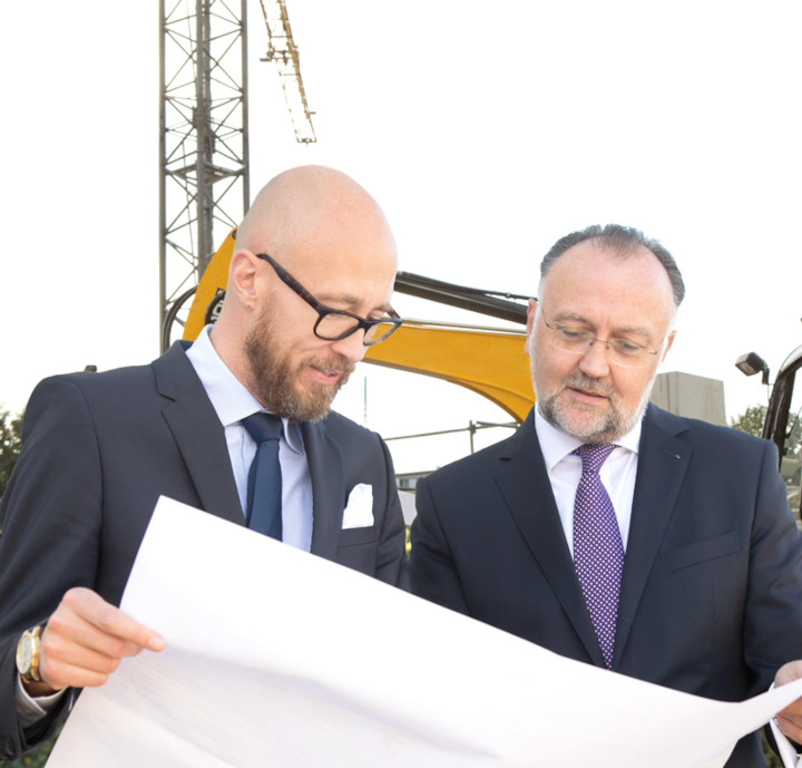 Herr Petri und Herr Beyl unterhalten sich auf einer Baustelle über die Rechtsgrundlagen.